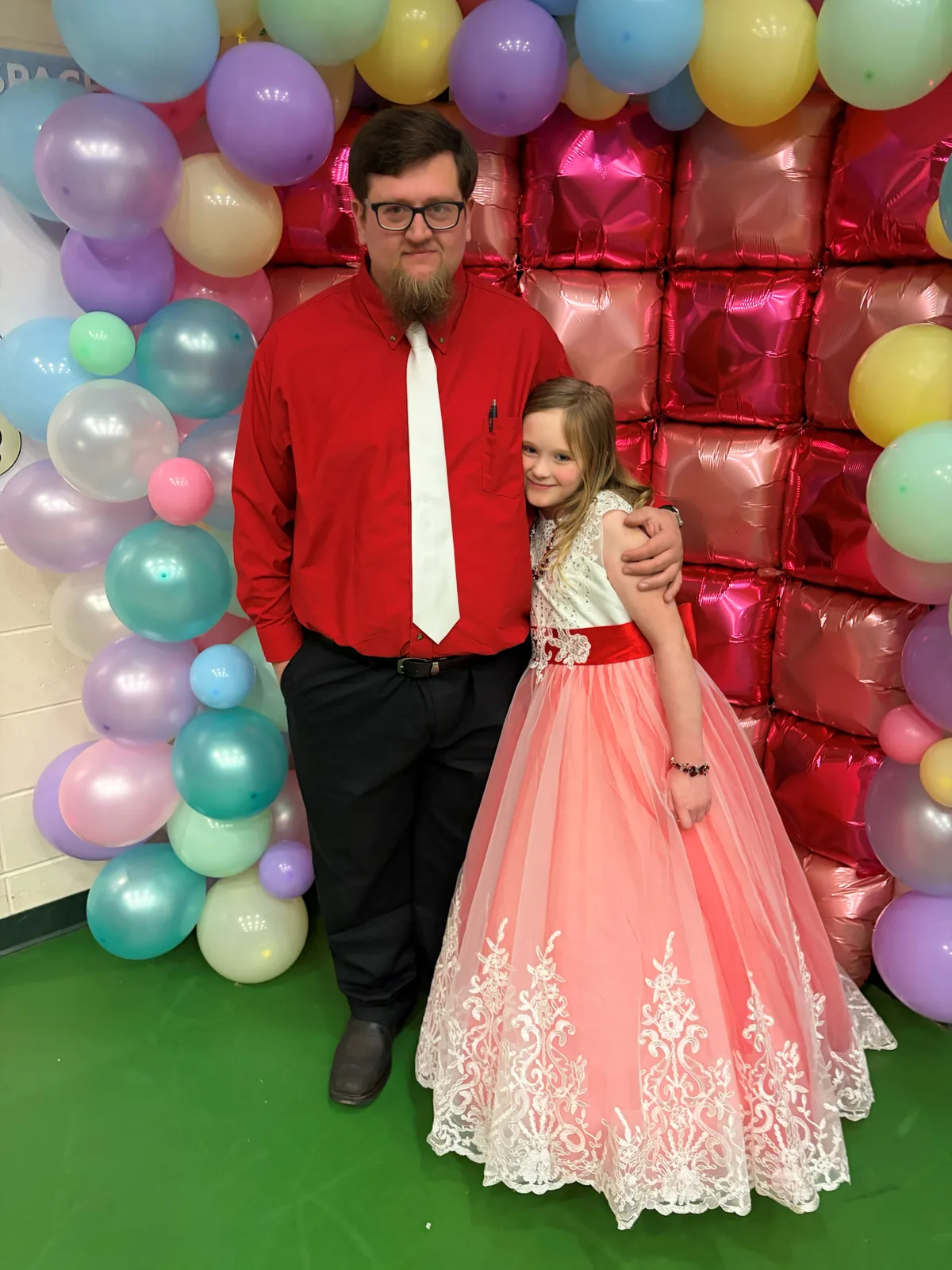 Joseph Cleveland standing for a photo with a child.